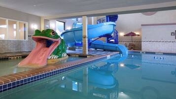 An indoor swimming pool with a frog water slide and a blue water play structure.