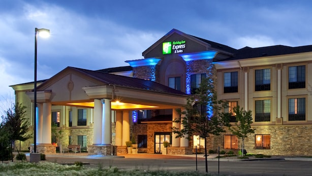 A Holiday Inn Express hotel with a stone facade, large columns, and a covered entrance. - Holiday Inn Express Hotel & Suites Longmont by IHG (Longmont)