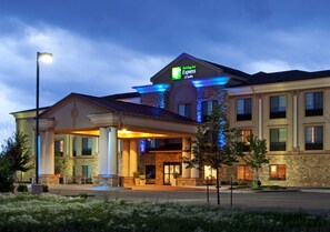 A Holiday Inn Express hotel with a stone facade, large columns, and a covered entrance. - Holiday Inn Express Hotel & Suites Longmont by IHG (Longmont)