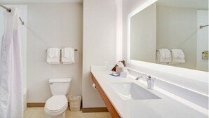 A bathroom with a toilet, sink, and mirror. - Holiday Inn Express Hotel & Suites Quincy I-10 by IHG (Quincy)