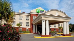 A Holiday Inn Express building with a covered entrance and a fountain. - Holiday Inn Express Hotel & Suites Quincy I-10 by IHG (Quincy)