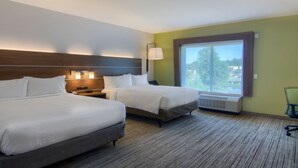 A hotel room with two beds, a nightstand, a lamp, and a large window with a view. - Holiday Inn Express Hotel & Suites Quincy I-10 by IHG (Quincy)
