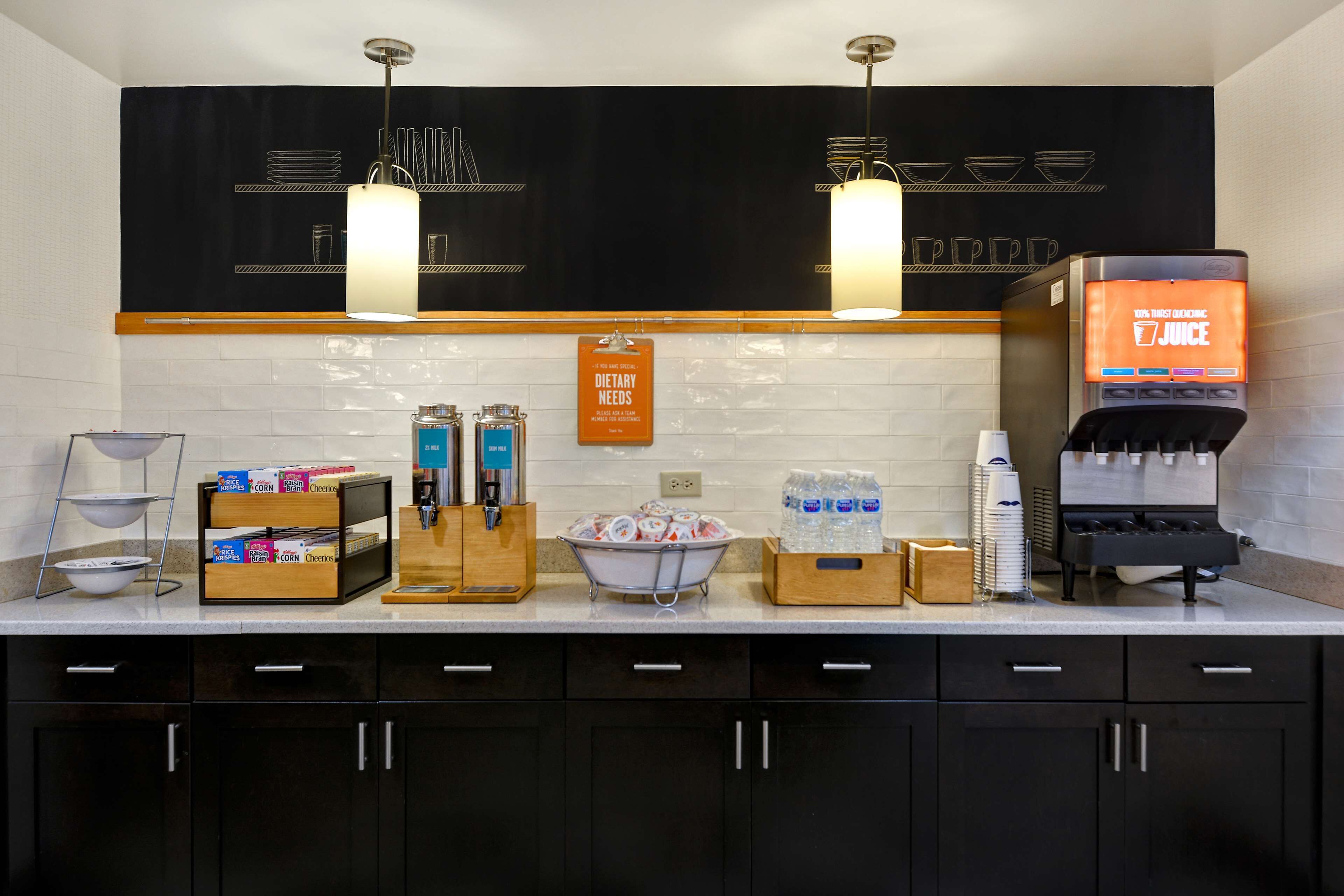 A kitchen area with a coffee machine, water dispenser, and various food items on the counter.