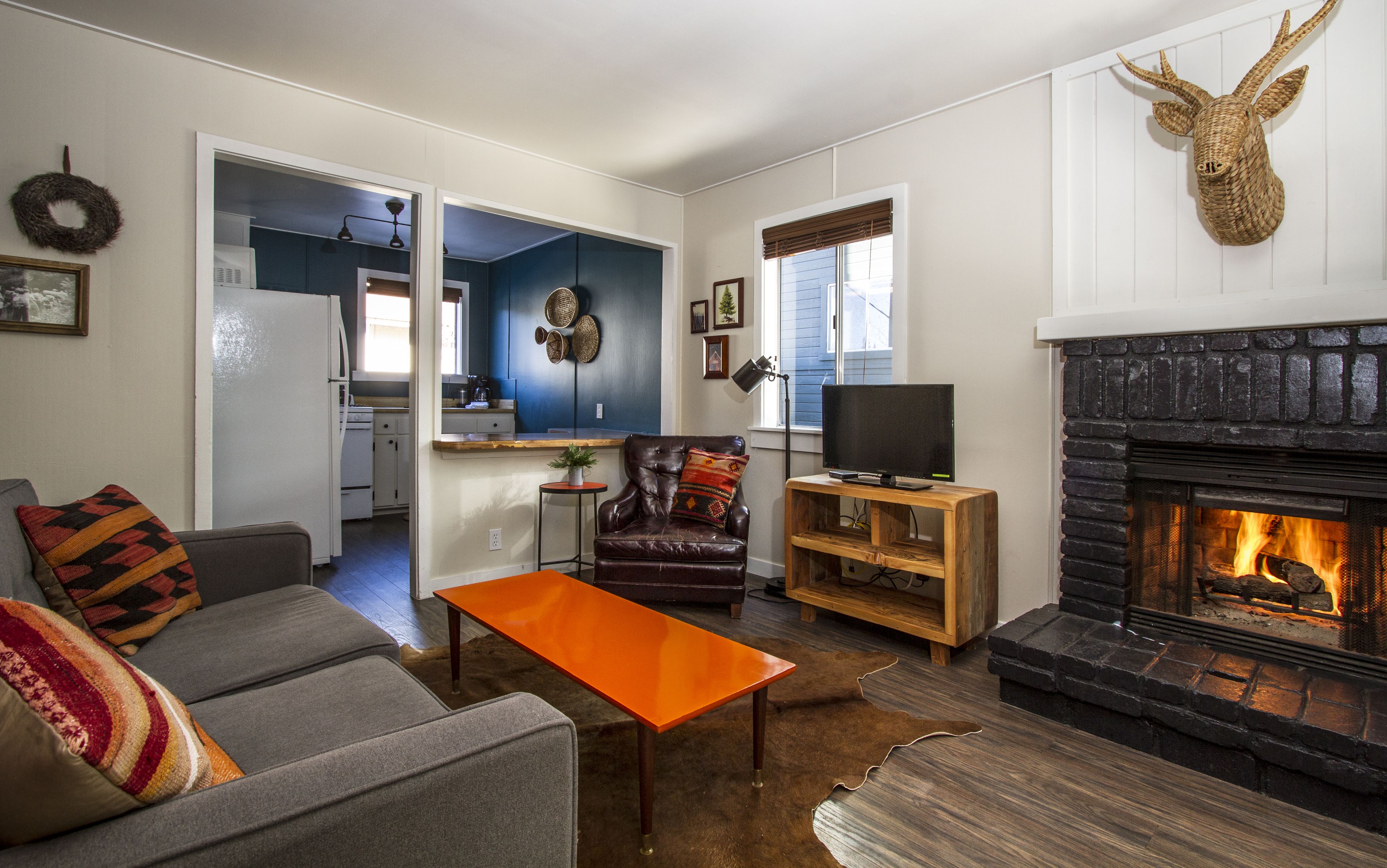 A living room with a fireplace, a television, a sofa, and a coffee table.