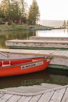 A row of boats docked at a pier with a label "NOON LODGE".