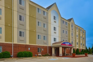 A multi-story hotel with a prominent entrance labeled 'Candlewood Suites.'