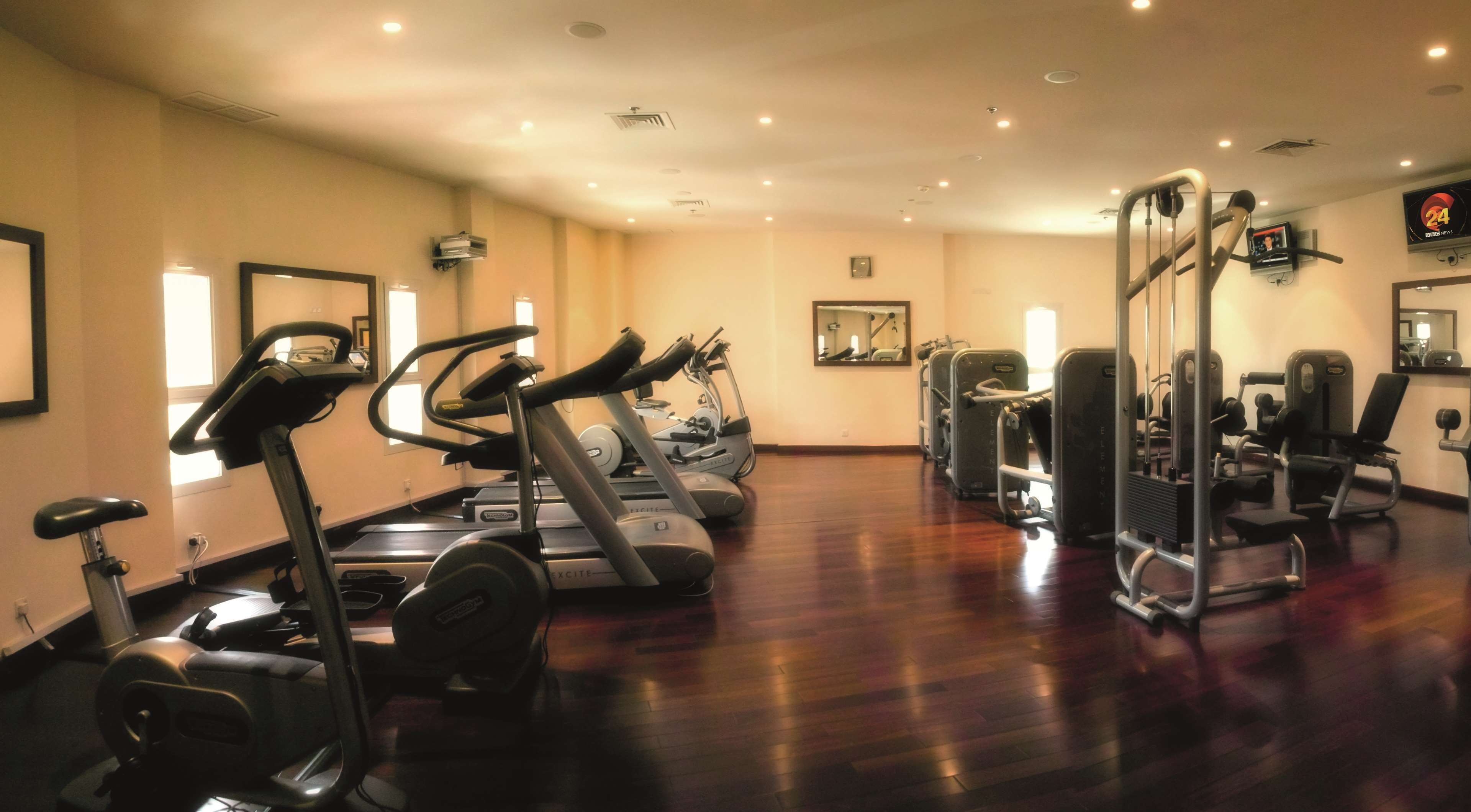 Ein Fitnessstudio mit Laufbändern, Crosstrainern und Gewichtsmaschinen.