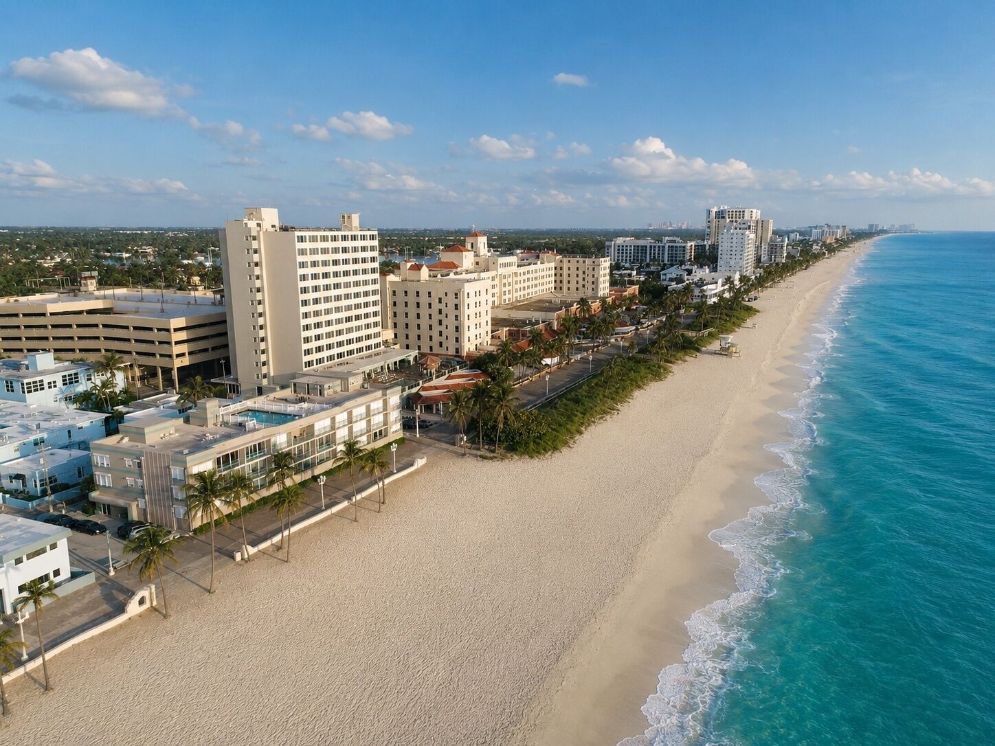 A coastal hotel with multiple buildings, a beach, and ocean views.