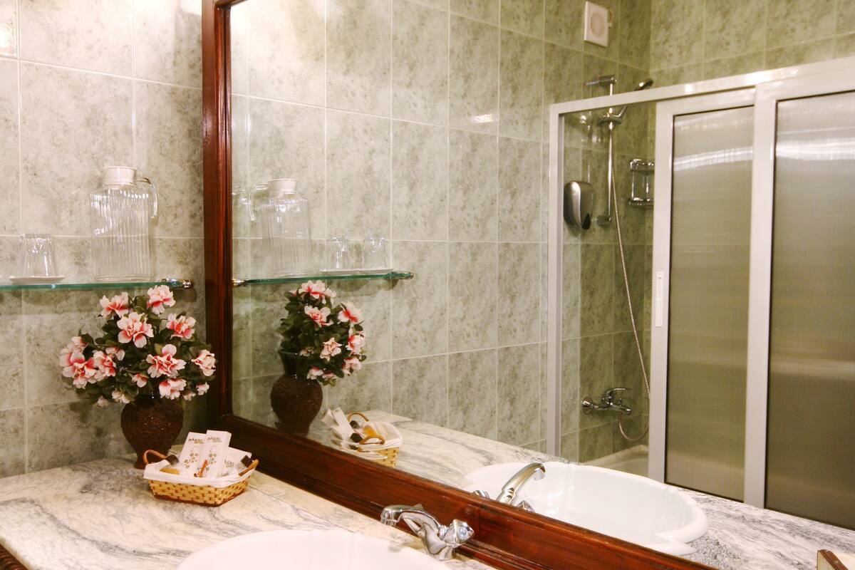 combined shower/bathtub, designer toiletries, hair dryer, bathrobes
