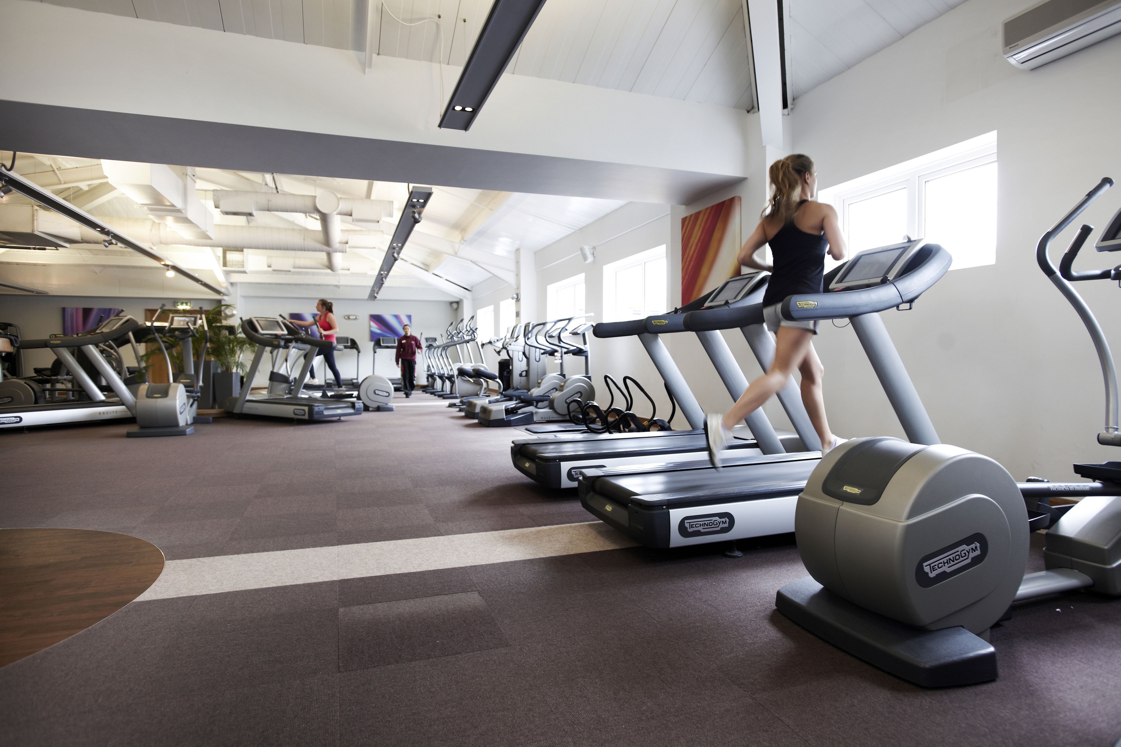 A gym with multiple treadmills and exercise equipment.