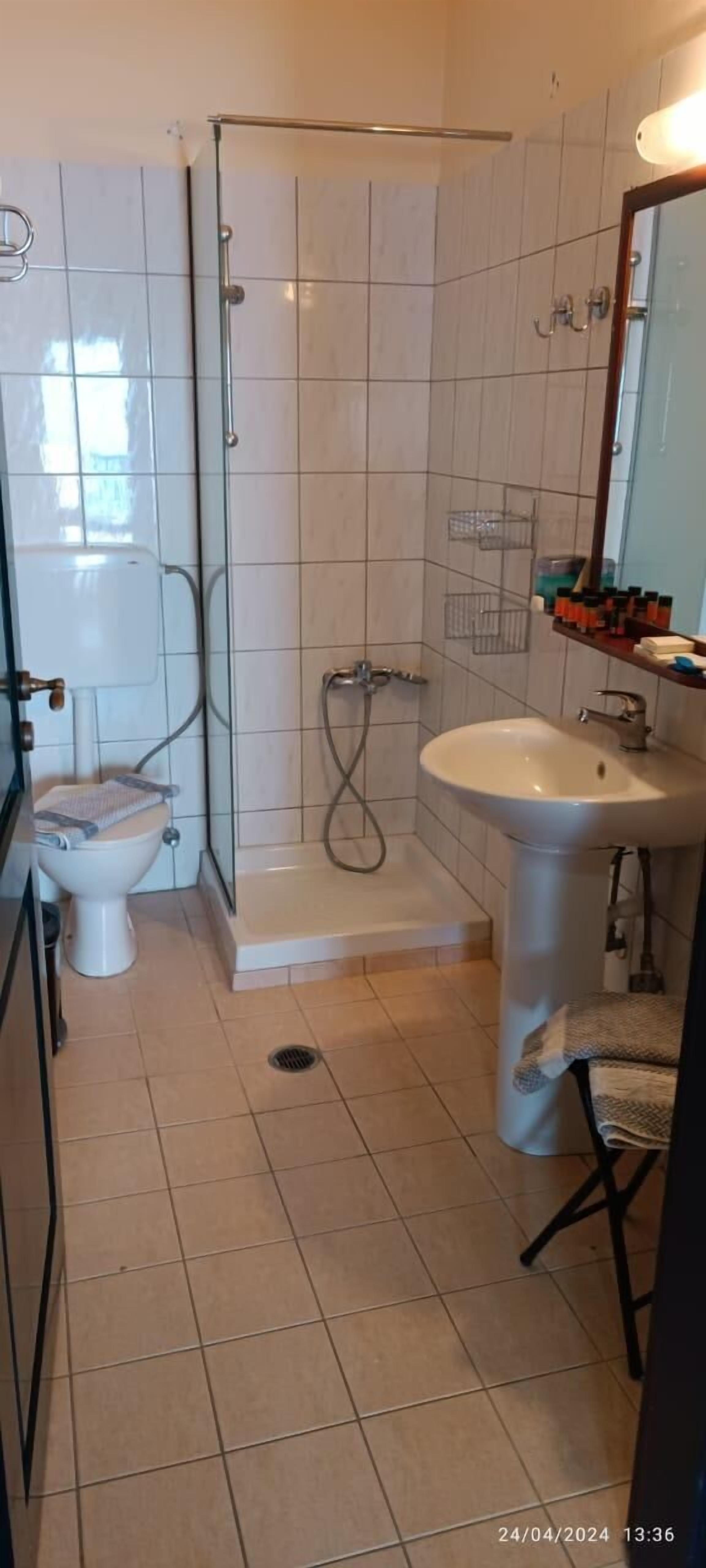 A bathroom with a toilet, sink, and glass-enclosed shower.