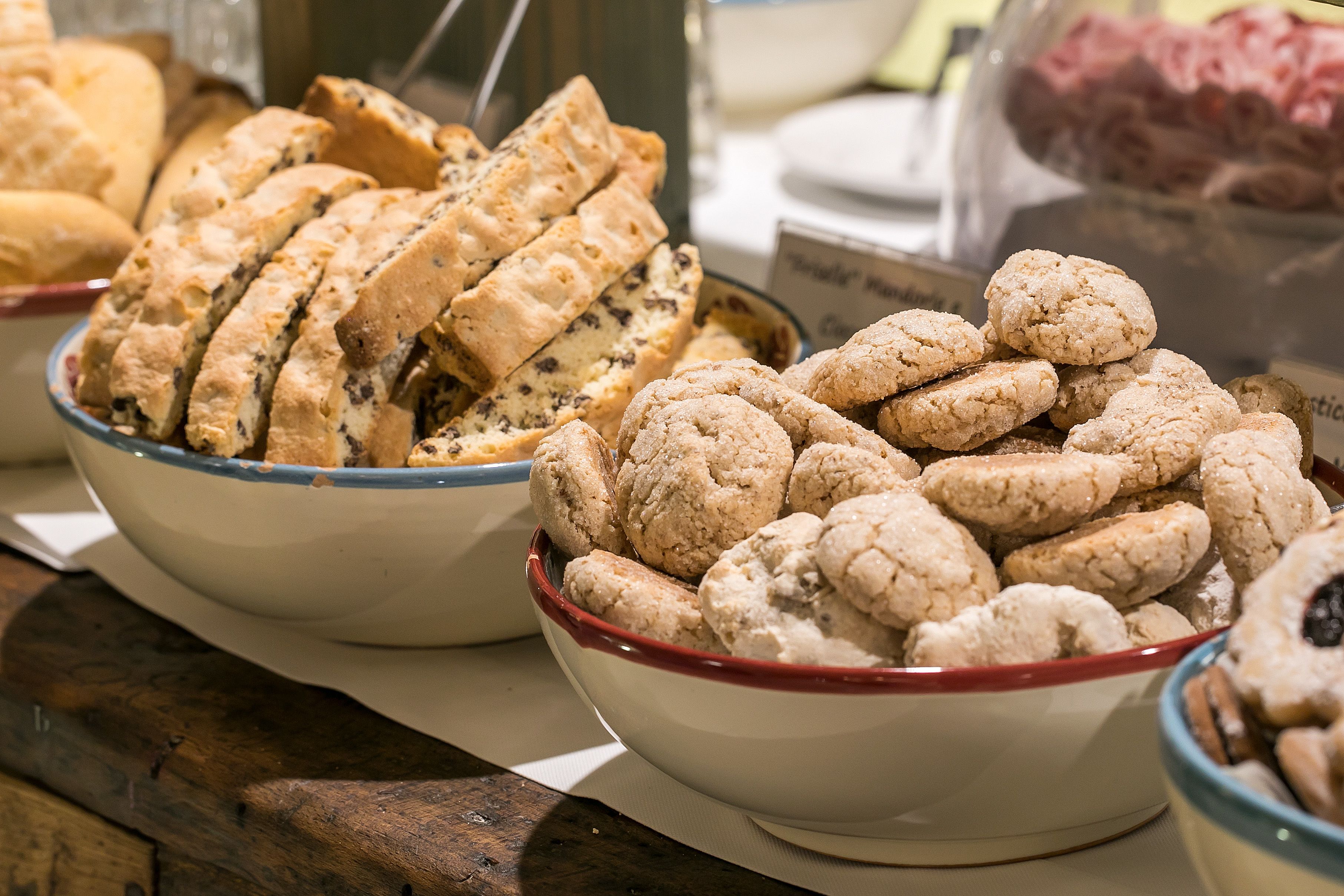 A display of various baked goods, including sliced bread and cookies, arranged in bowls.
