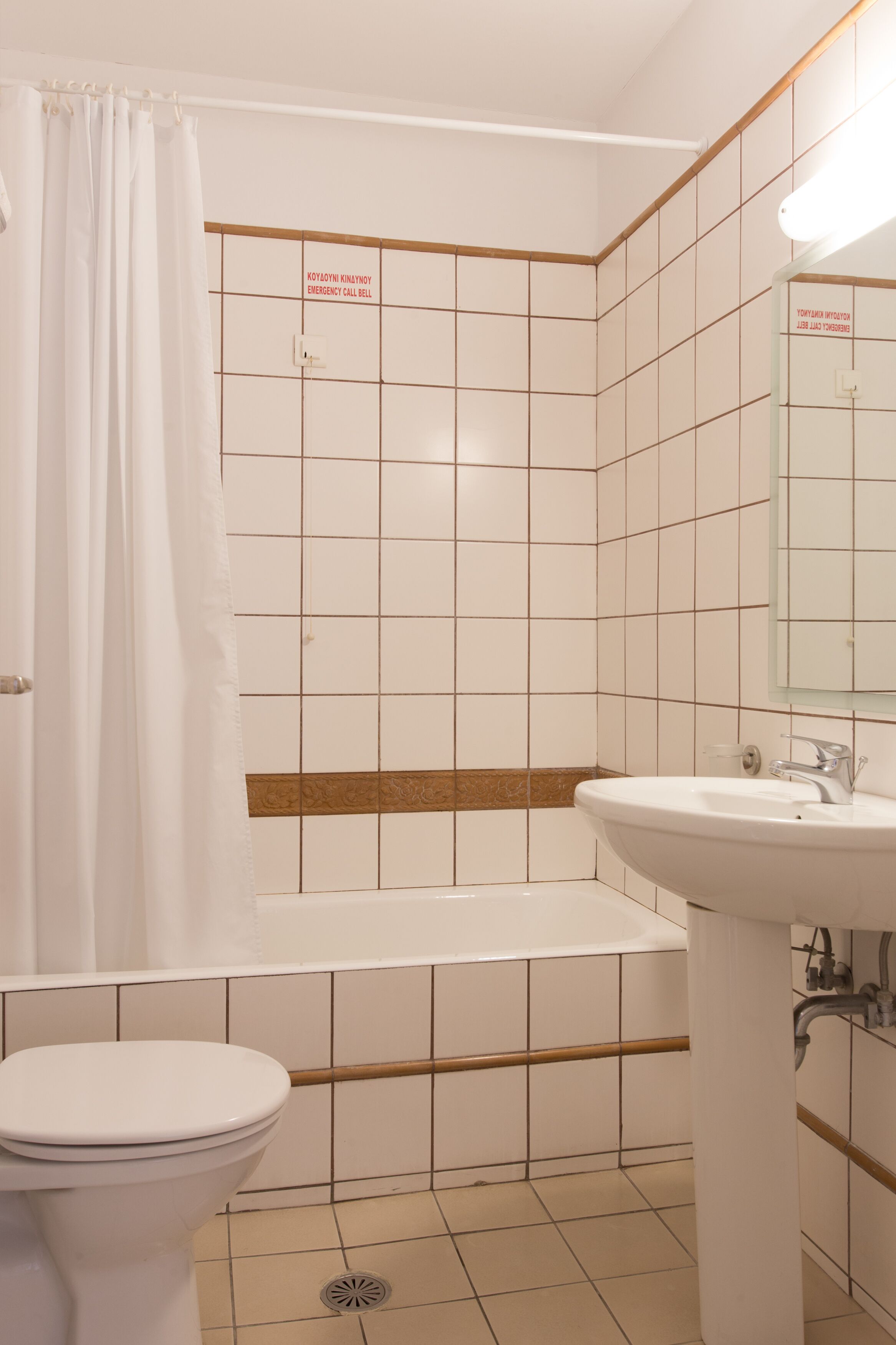 A bathroom with a toilet, a sink, and a bathtub.