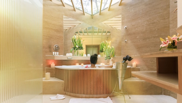 A modern bathroom with a wooden bathtub, a large mirror, and a skylight. - The Westin Sohna Resort & Spa (Sohna)