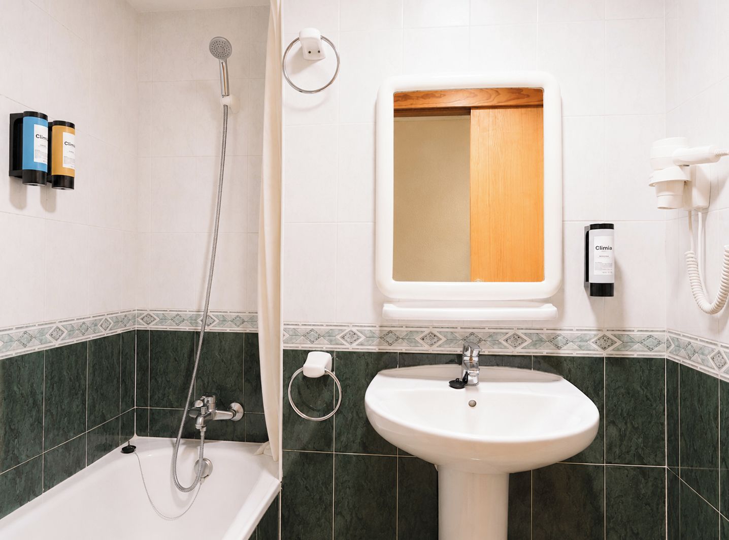 A bathroom with a bathtub, a sink, and a shower.