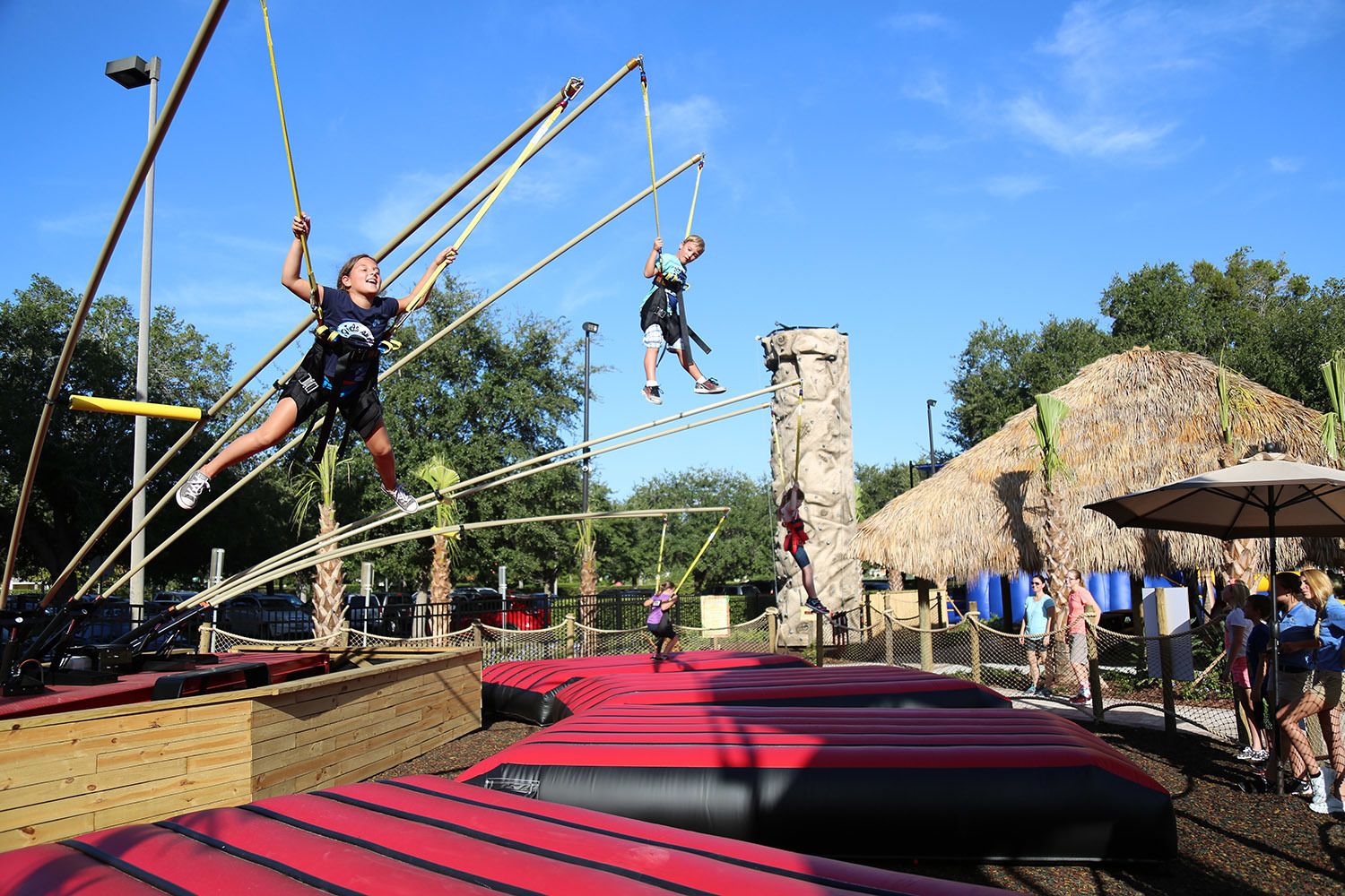 An outdoor obstacle course with wooden platforms and ropes.