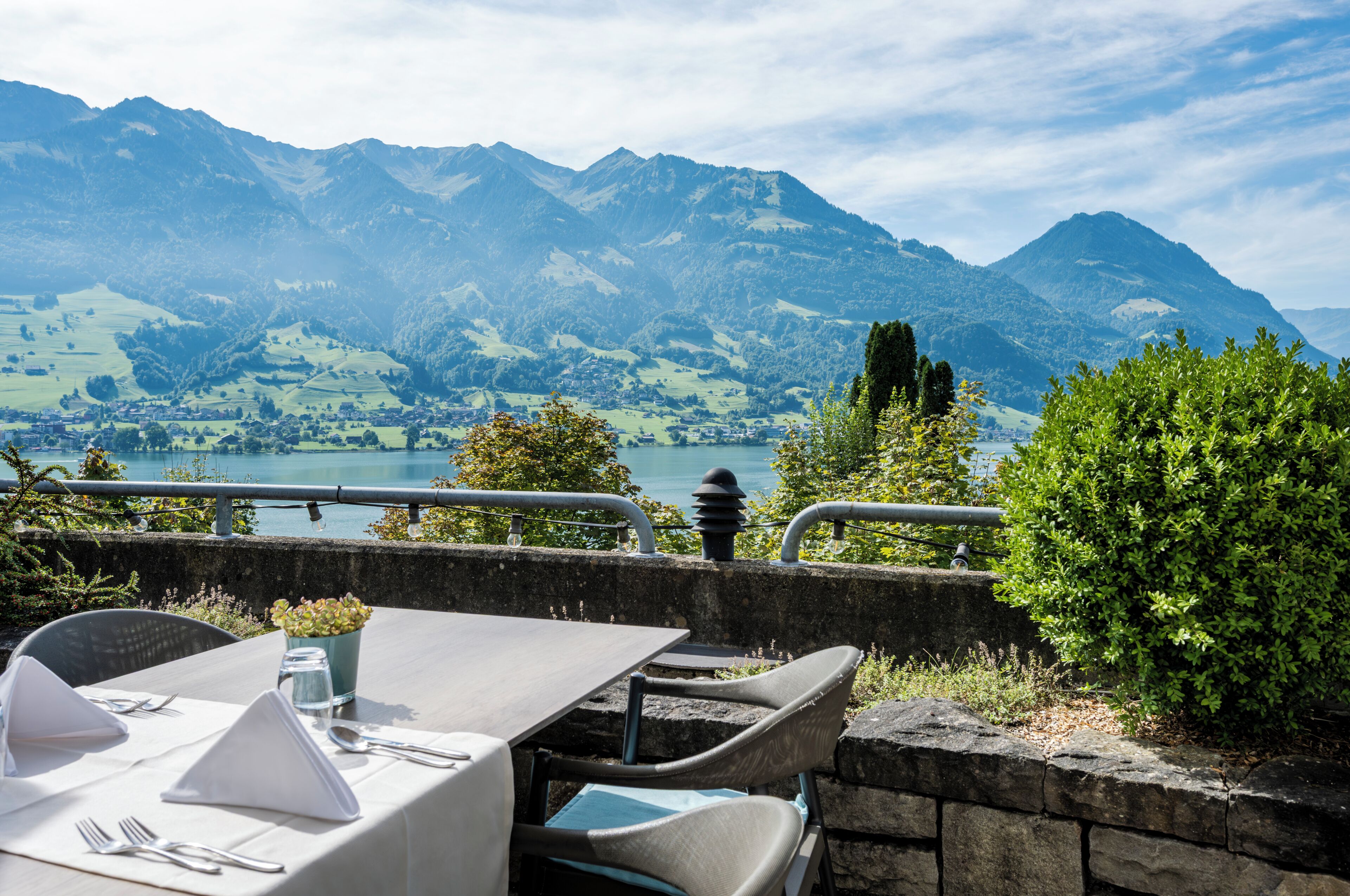 A table set for dining with a mountain view in the background.