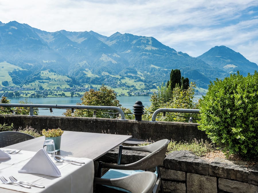 A table set for dining with a mountain view in the background.
