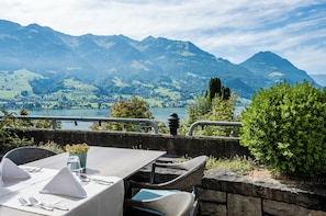 A table set for dining with a mountain view in the background. - Seehotel Wilerbad (Sarnen)
