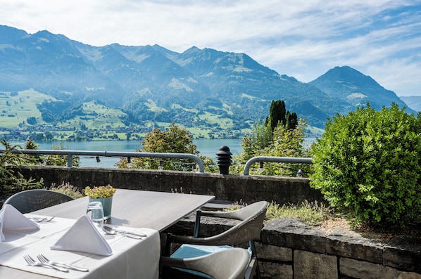 A table set for dining with a mountain view in the background.