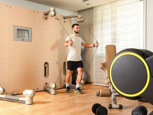 A gym with exercise equipment, including a treadmill, weights, and resistance bands. - Sofitel Luxembourg Le Grand Ducal (Luxembourg City)