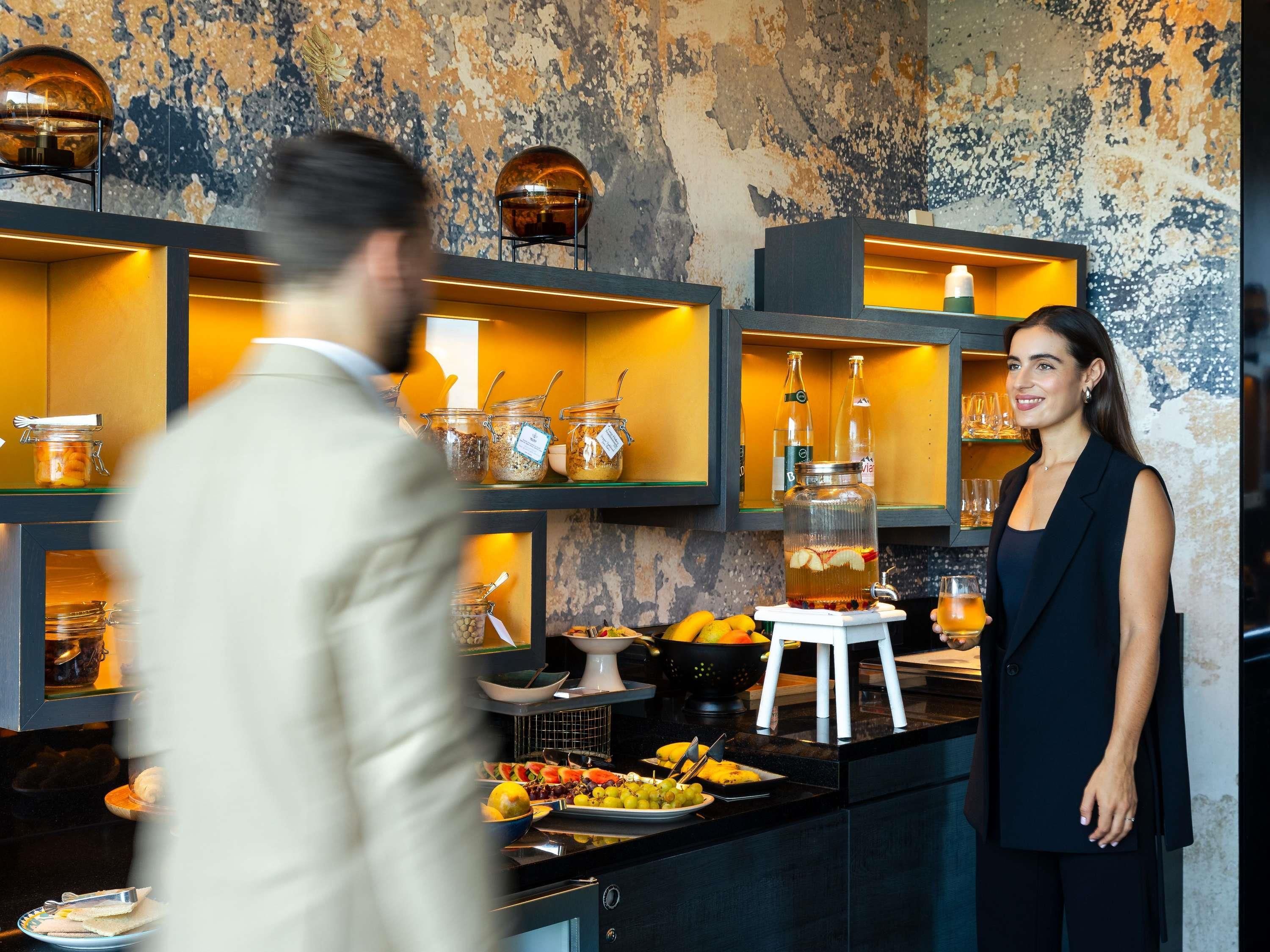 A buffet setup with various food items and a beverage dispenser.