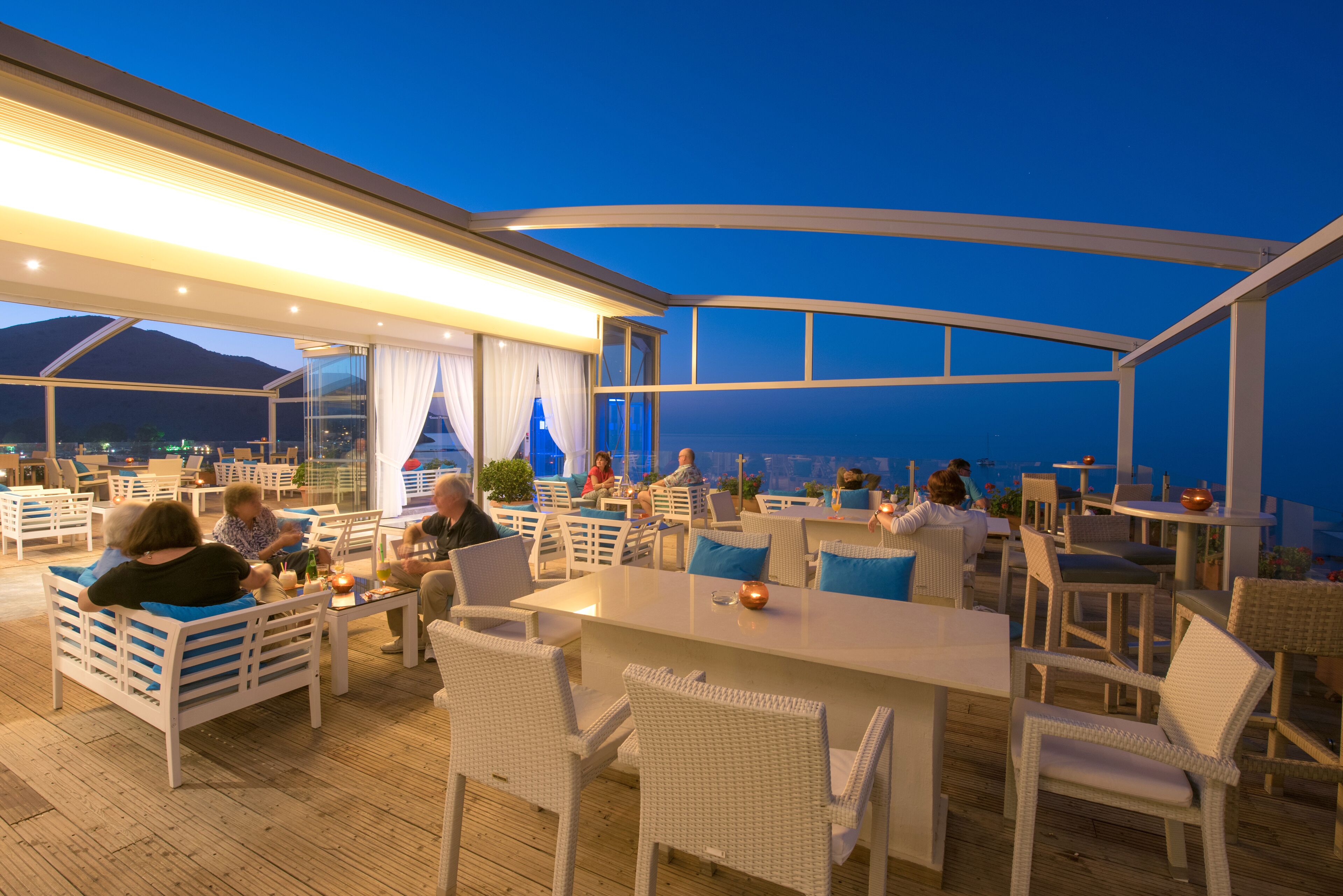 An outdoor seating area with tables and chairs, overlooking a scenic view.