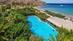 A resort with a large swimming pool, beach, and mountainous backdrop. - Corissia Princess Hotel (Apokoronas)