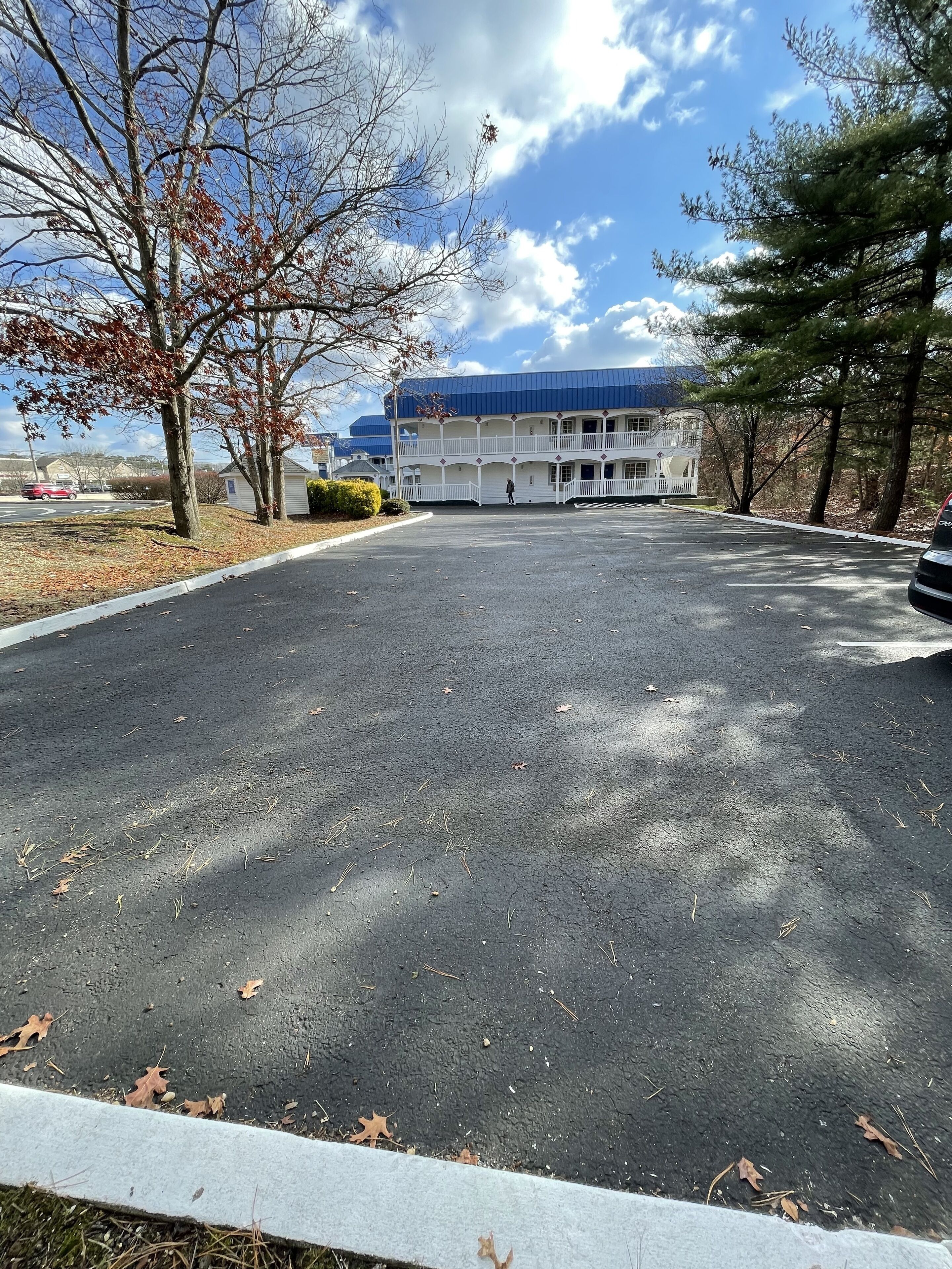 A parking lot with a building in the background.