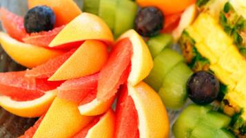 A variety of fresh fruits including oranges, grapefruits, and melons.