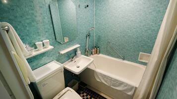 A bathroom with a sink, mirror, and bathtub.