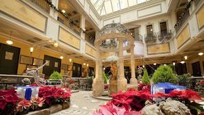 A hotel lobby with a central fountain, multiple balconies, and a tiled floor. - Hotel Monterey Sapporo (Sapporo)