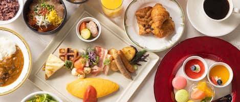 A variety of dishes including a plate with grilled vegetables, a bowl of soup, and several small dishes with different foods.