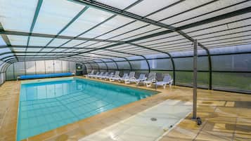 Indoor pool, open 10:00 AM to 7:00 PM, pool loungers