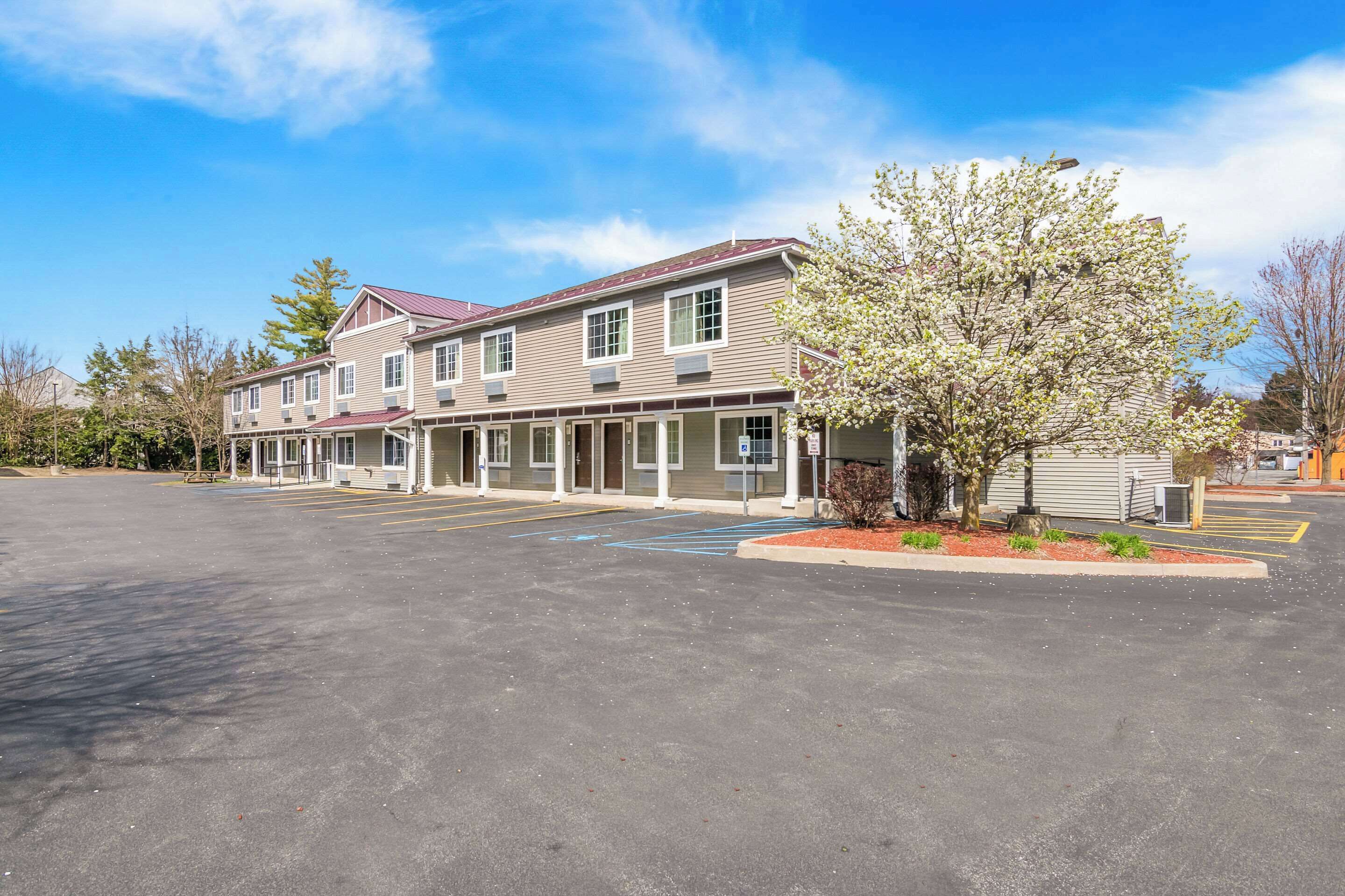 A two-story building with a parking lot in front.