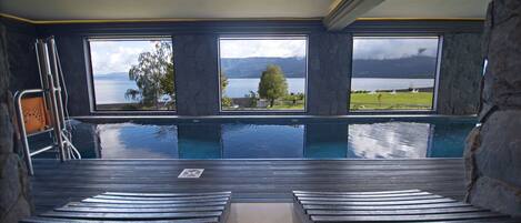 A spa area with a view of a lake and mountains.