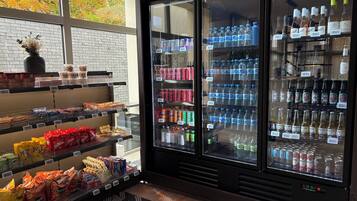 A vending machine stocked with snacks and beverages, including chips, sodas, and bottled water.