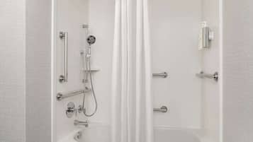 A modern bathroom with a shower, bathtub, and toilet.