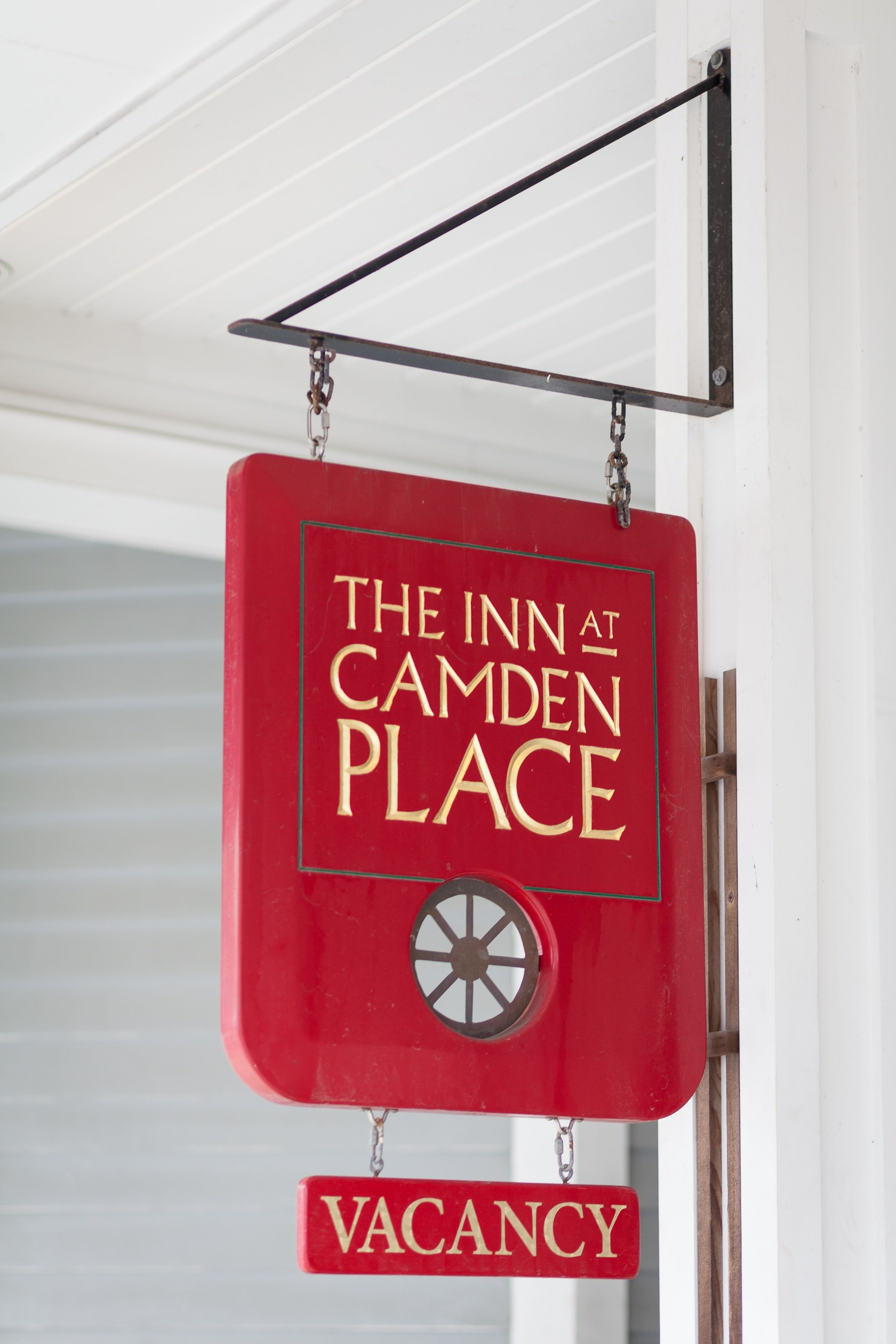 A red sign with "The Inn at Camden Place" and "VACANCY" indicating available rooms.