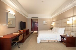 A hotel room with a bed, a desk, a chair, a television, and a mirror. - Best Western Plus Fuzhou Fortune Hotel (Fuzhou)