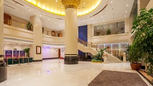 A spacious lobby with a central column, a staircase, and multiple levels. - Best Western Plus Fuzhou Fortune Hotel (Fuzhou)