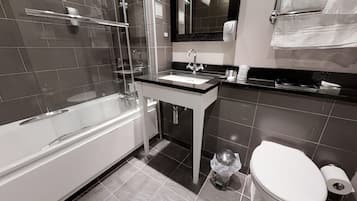 A modern bathroom with a bathtub, sink, and toilet.