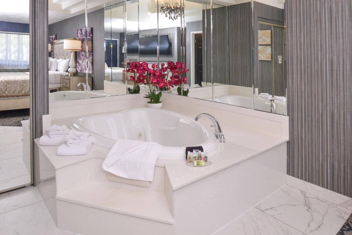 combined shower/bathtub, designer toiletries, hair dryer, towels