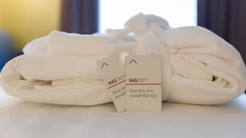 A neatly folded white towel with a tag that reads "IHG Rewards Club" and "Your key to a wonderful stay."