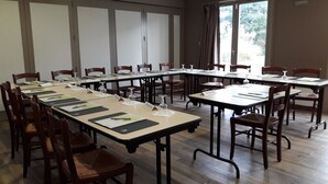 A conference room with long tables, chairs, name cards, and glassware. - Campanile Montluçon - St Victor (Saint-Victor)