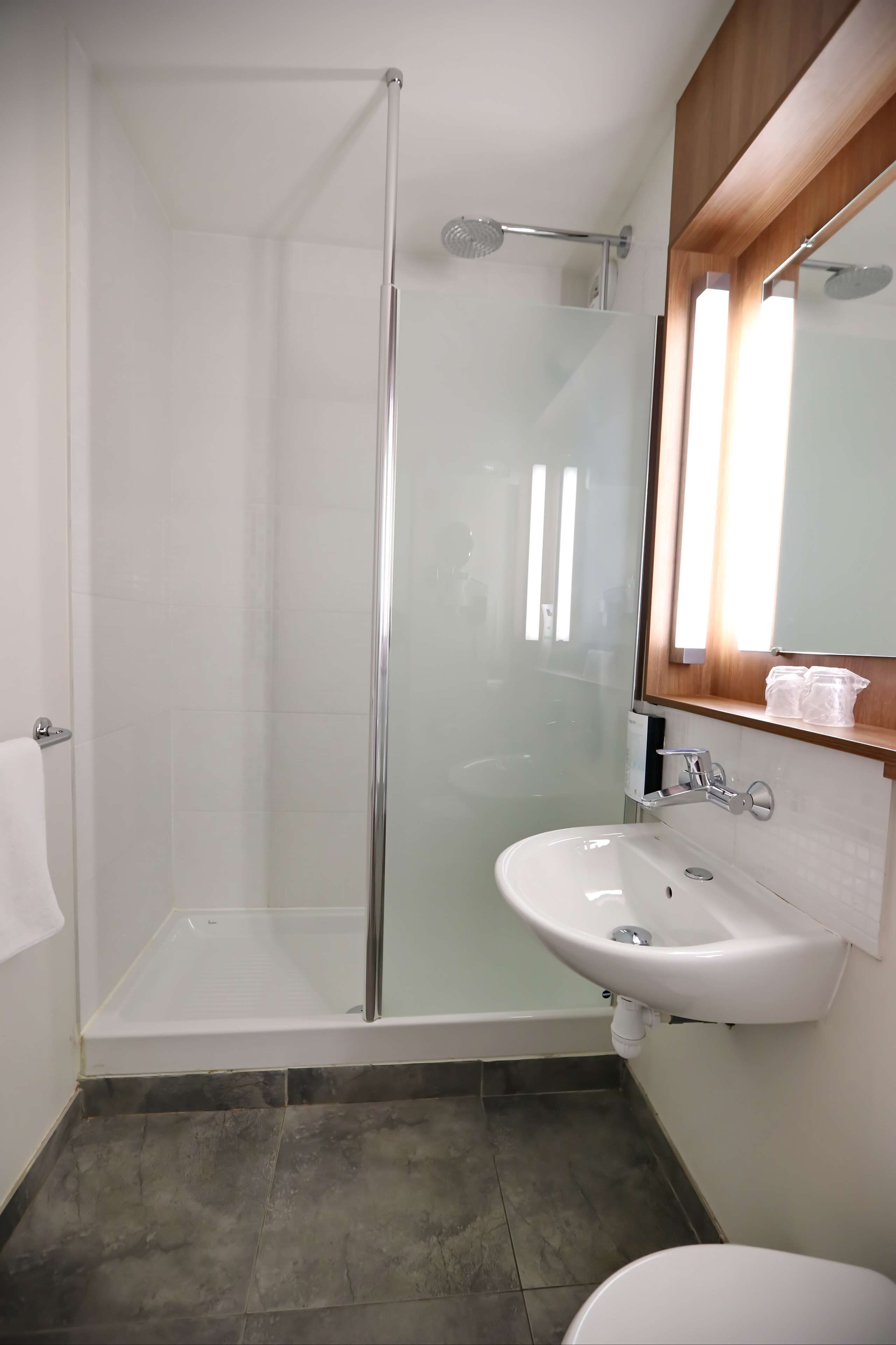 rainfall showerhead, eco-friendly toiletries, hair dryer, towels