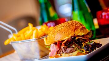 A meal consisting of a sandwich and fries on a plate.