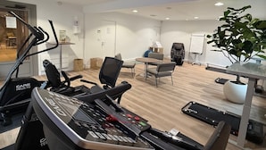 A modern office space with a treadmill, office chairs, a whiteboard, and a potted plant. - Campanile Epinay Sur Orge Savigny Sur Orge (Epinay-sur-Orge)