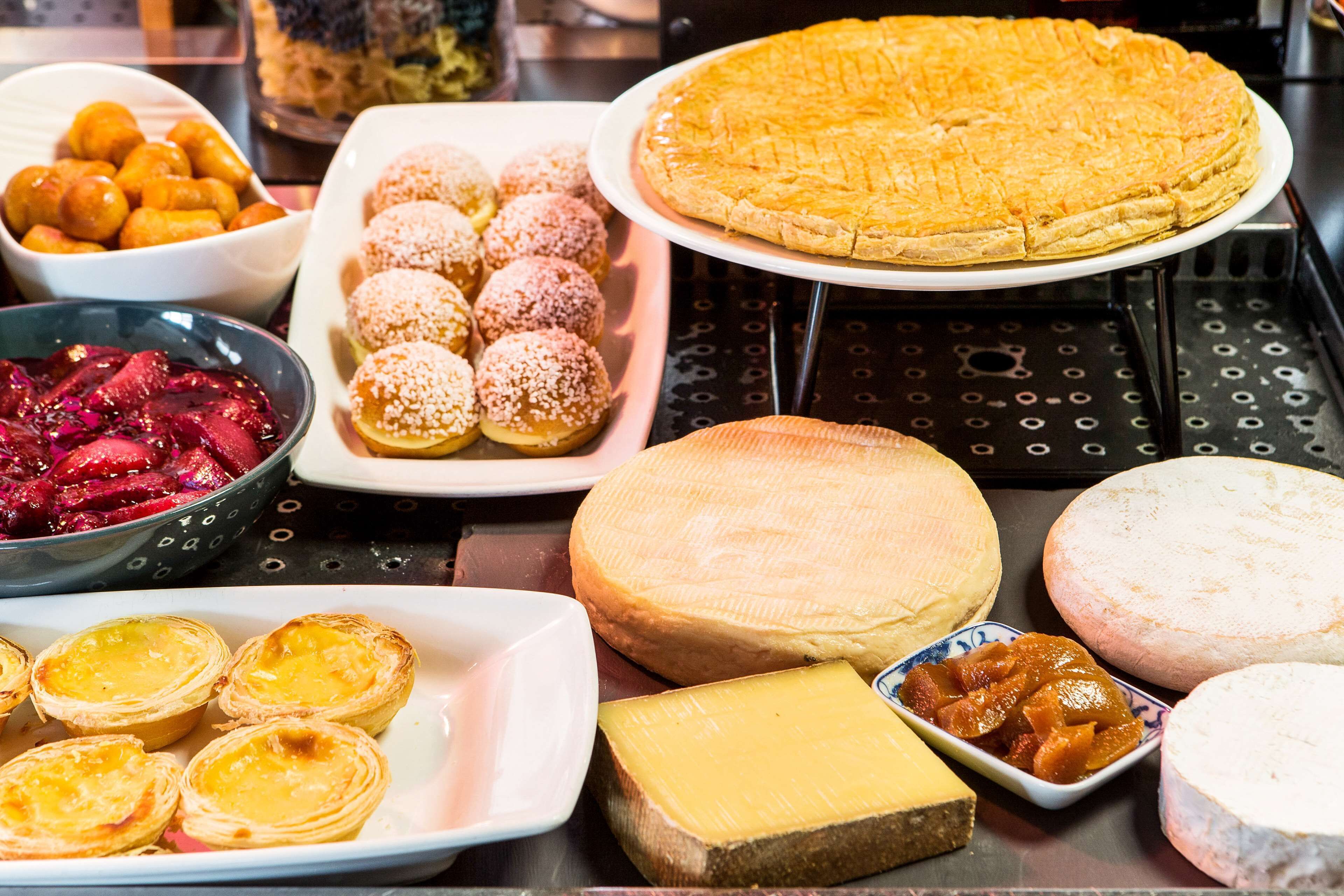 A variety of cheeses and pastries on display.