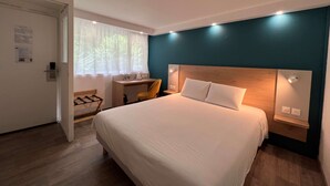 A modern hotel room with a large bed, a desk, and a chair. - KYRIAD Sedan (Sedan)